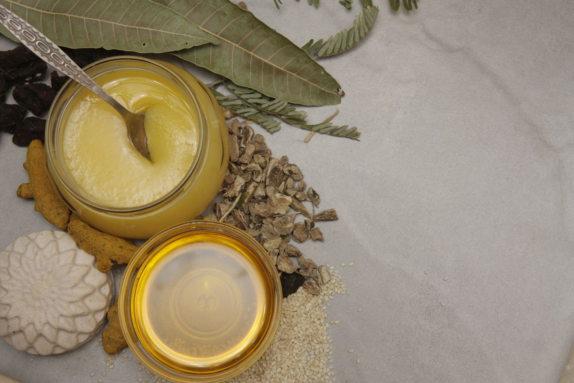 Shilajit Honey Syrup for immunity – A top-view of natural ingredients including honey, herbs, and leaves, perfect for healthy lifestyle themes.